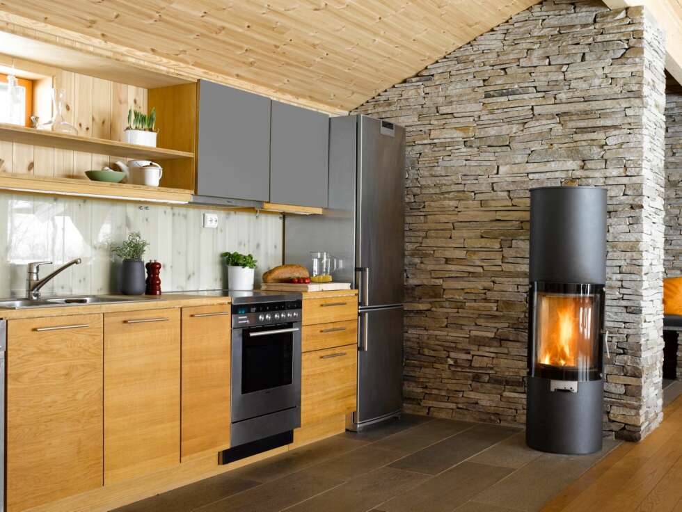 Kjøkkenet er tilbaketrukket mot vollen bak, og henvender seg mot spisestuen. Innredningen er av Lindal Design. Kjøkkenet er tilbaketrukket mot vollen bak, og henvender seg mot spisestuen. Innredningen er av Lindal Design.