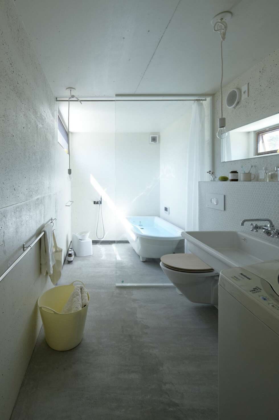 BAD: Det stilrene badet har et industrielt uttrykk med betonggulv og vegger. Badet er bygget ut fra den en siden på huset med en døråpning mellom hoveddelen og badet. BAD: Det stilrene badet har et industrielt uttrykk med betonggulv og vegger. Badet er bygget ut fra den en siden på huset med en døråpning mellom hoveddelen og badet.