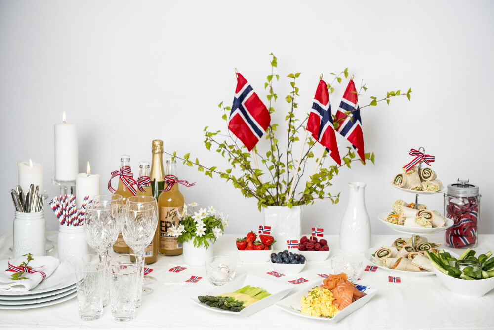 KOLDTBORD: - Maten skal stå i sentrum på 17. mai, fastslår Stine Rydningen, visual merchendiser hos Christiania Glassmagasin. Dette lekre koldtbordet er dekket med bjørkekvister og flagg i en vase, en søt bukett hvitveis og sløyfebånd i det norske flaggets farger. Produkter fra Christiania Glasmagasin. KOLDTBORD: - Maten skal stå i sentrum på 17. mai, fastslår Stine Rydningen, visual merchendiser hos Christiania Glassmagasin. Dette lekre koldtbordet er dekket med bjørkekvister og flagg i en vase, en søt bukett hvitveis og sløyfebånd i det norske flaggets farger. Produkter fra Christiania Glasmagasin.