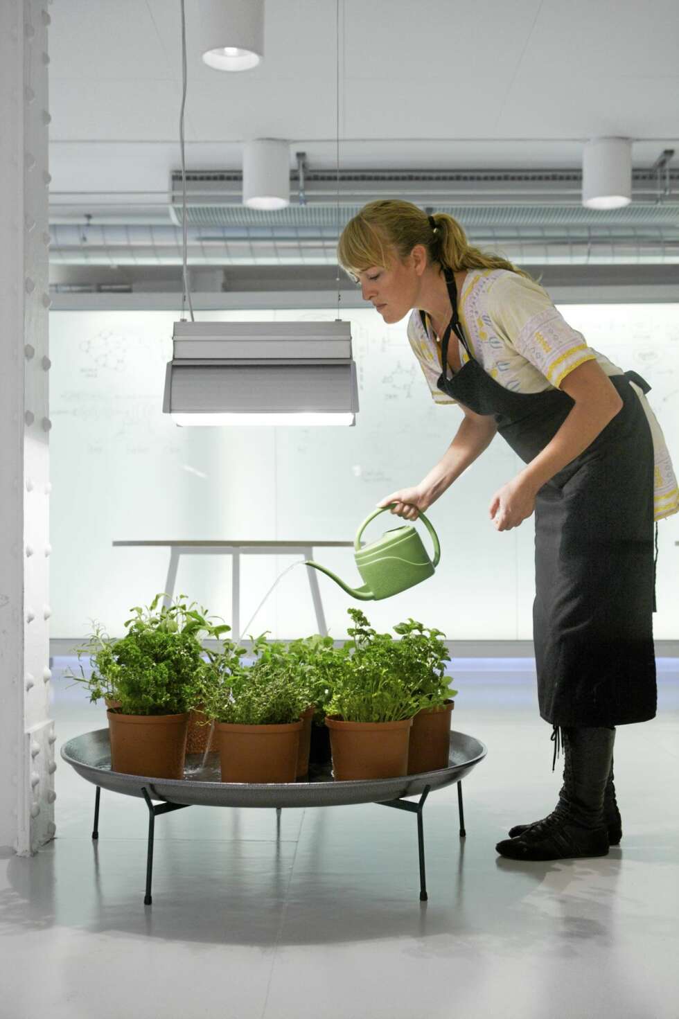 I kjøkkenhagen finnes et urtebord med en gammel gartnerlampe med plantelys nedsenket over den. I kjøkkenhagen finnes et urtebord med en gammel gartnerlampe med plantelys nedsenket over den.