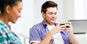 education concept - students looking at phones and tablet pc at school education concept - students looking at phones and tablet pc at school