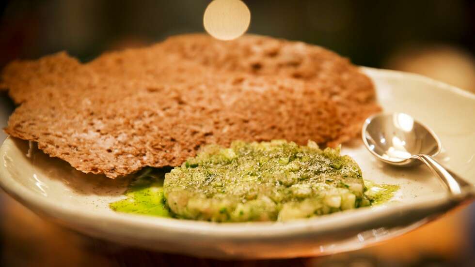 RESTAURANT MÅLTID: Makrelltartar med rå selleri stykker og snittet gressløk. På toppen er det drysset blæretangspulver og det er en grøn selleritopolje. De sprø flakene er malt knekkebrød. RESTAURANT MÅLTID: Makrelltartar med rå selleri stykker og snittet gressløk. På toppen er det drysset blæretangspulver og det er en grøn selleritopolje. De sprø flakene er malt knekkebrød.