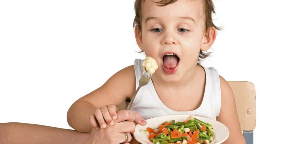 Little boy tasting vegetable salad Little boy tasting vegetable salad