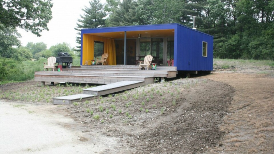 ÅPEN LØSNING: Dette minihuset på 73 kvadratmeter har en åpen stue og kjøkkenløsning med en skillevegg i glass. Den ligger idyllisk til i vannkanten av en stor innsjø.