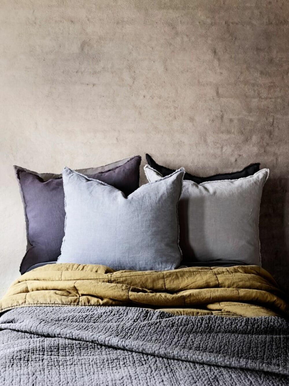 RØFT SOVEROM: Mørke og mystiske farger er populært i høst, også på soverommet. Som dette sengeteppet og putene fra Olsson & Jensen. 