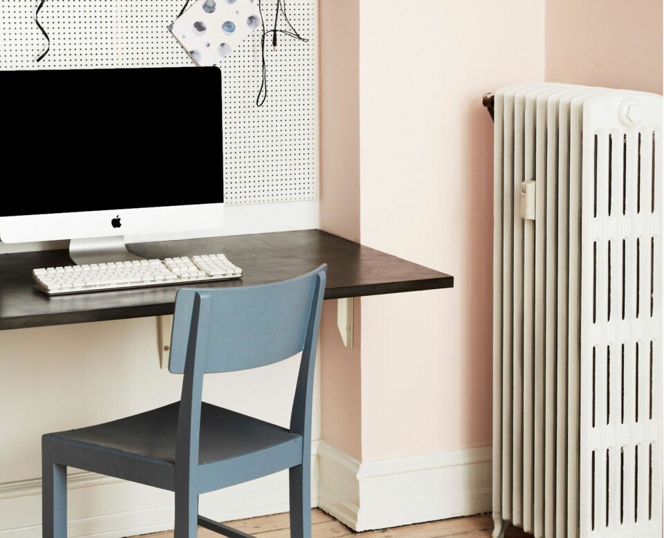 DISKRET: Veggen og oppslagstavlen ble holdt i lyse nyanser, slik at kontoret fåt et lett og enkelt uttrykk. Bordplaten fra Ikea er satt fast til veggen med to hylleknekter, slik at det ser ut som om bordet svever.