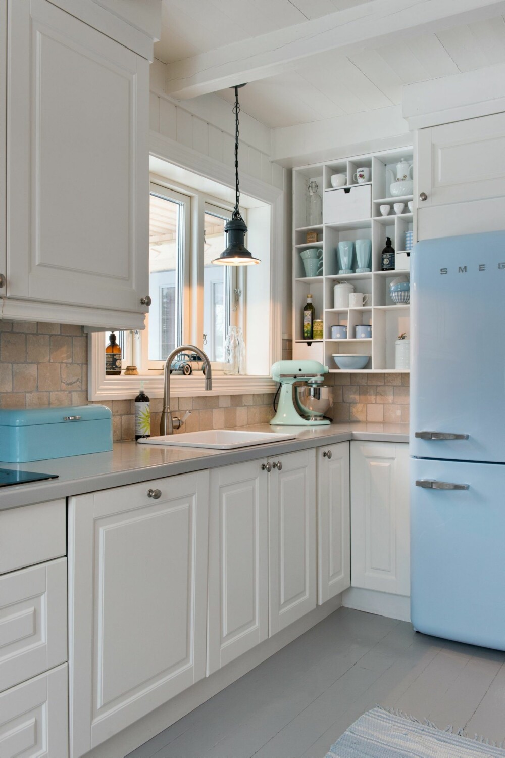 FARGEKLATTER: Det blå kjøleskapet fra Smeg er Marias favoritt. Det gir rommet en leken karakter, og sørger for at uttrykket ellers ikke blir for unisont. Kjøkkeninnredningen heter Malt Fylling Hvit og er fra Strai Kjøkken.