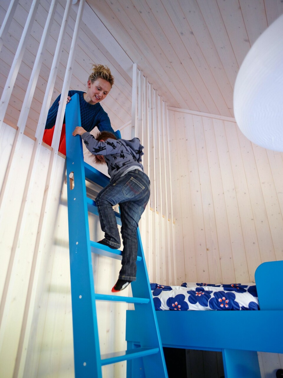 SMART HEMS: Takhøyden gir rommene luft og god romlighet. Alt av
møbler og stiger opp til
hemsen er spesialtegnet for
å utnytte plassen
maksimalt. Barna elsker å
klatre opp i sin egen sfære.
Siri tar imot sønnen Storm. (FOTO: Ragnar Hartvig)