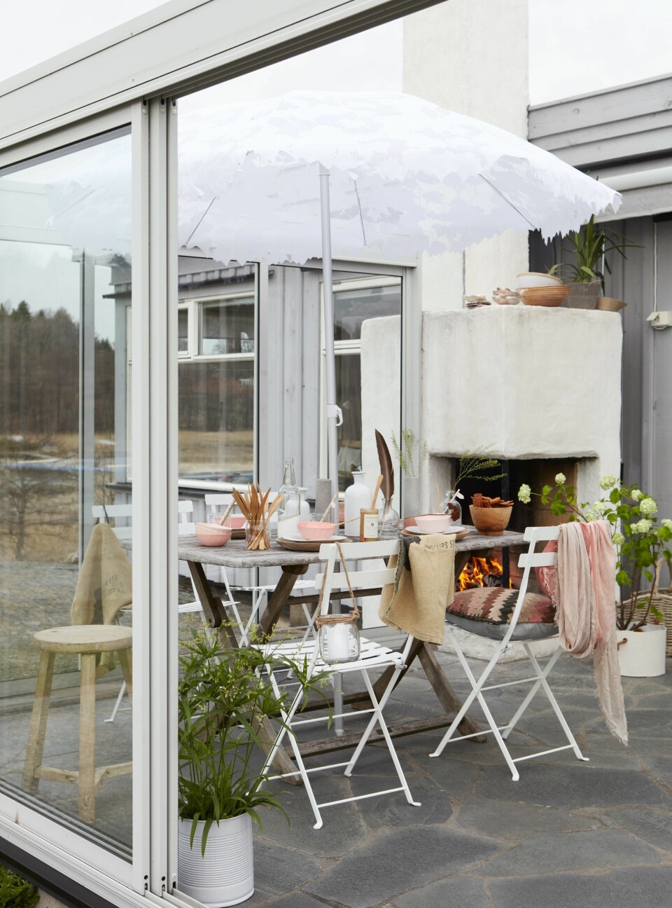 GLASSET INN UTEPLASSEN: Uteplassen har skyvbare glassflater som kan åpnes i alle retninger. Dermed blir glassverandaen et sted man kan oppholde seg både når det blåser mye og når det blir trykkende varmt.