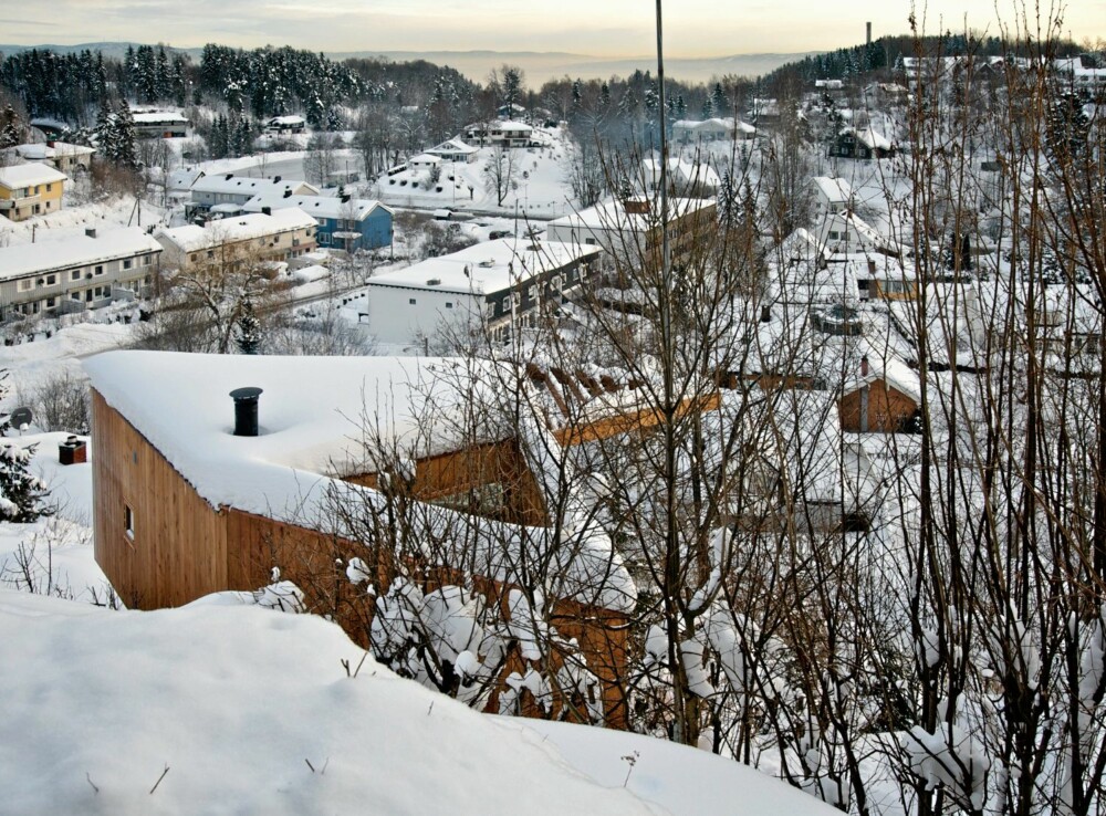 EN HEL LITEN VERDEN: Skrivestuen ligger på høydedrag over bebyggelsen. Midt i bygningen ligger det et trekantet indre gårdsrom som stenger seg av fra omgivelsene, og som er forrommet du må passere for å komme inn i skrivestuen.