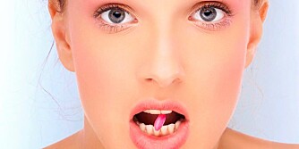 Portrait of healthy and fresh beautiful woman with pill in her mouth