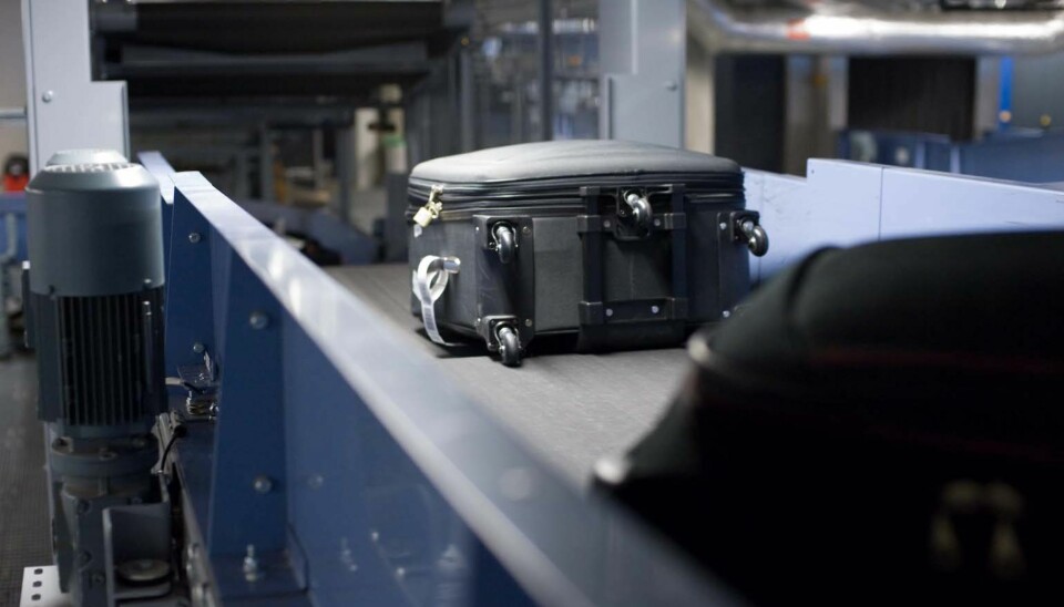 PÅ VEI: Kofferter forsvinner ned i sorteringsanlegget på Gardermoen. FOTO: Avinor
