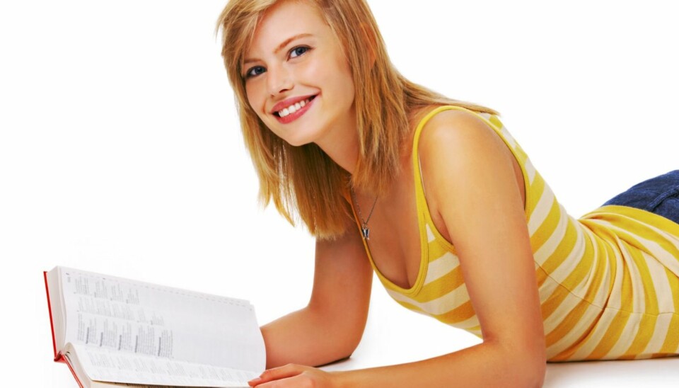 Casual student reading - Portrait of a young cute student studying in her book. This isolate was taken in our studio.
