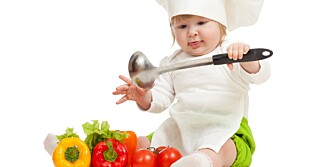 Kid in chef hat with healthy food vegetables