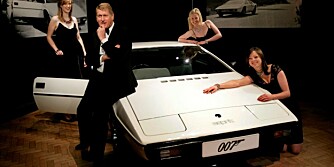 Auction house workers pose for pictures in front of a 1976 Lotus Esprit car from the 1977 James Bond film 'The Spy Who Loved Me', starring Roger Moore and Barbara Bach, during a presentation ahead of an auction in Bonhams auction house in central London, Thursday Nov. 13, 2008. The car is expected to fetch some 100,000-120,000 british pounds (121,900 - 146,309 Euro or 152,998 - 183.598 US Dollars) when it is sold next month. The vehicle is one of two Lotus cars driven in the film by Roger Moore's James Bond character. It turns into an amphibious car for the movie, driven both on land and underwater. (AP Photo/Lefteris Pitarakis)