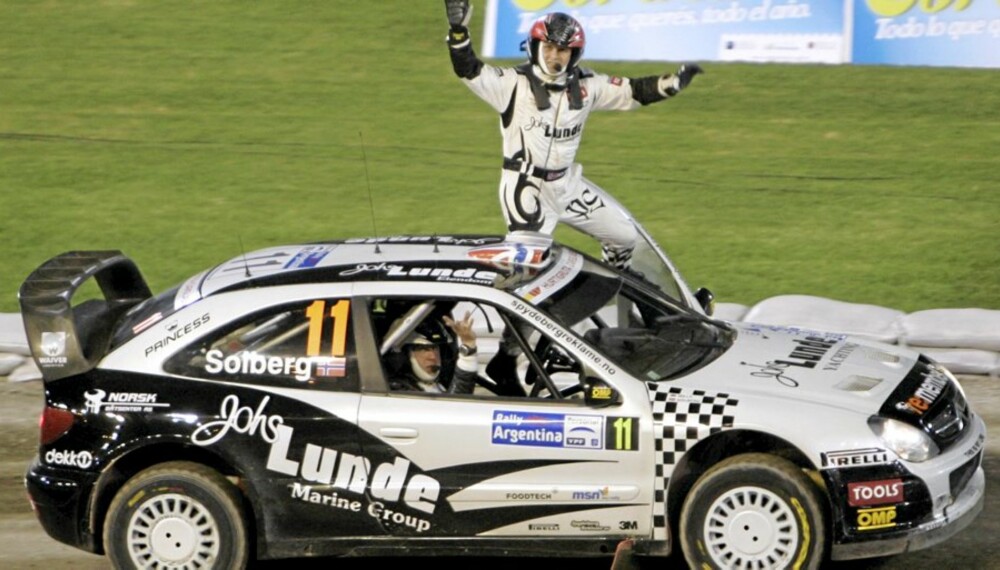 Petter Solberg of Norway, top, and his co-driver Philip Mills wave to fans from their Citroen Xsara after the first special of the WRC Argentina Rally at Cordoba Stadium in Cordoba, Argentina, Thursday, April 23, 2009. (AP Photo/Eduardo Di Baia)