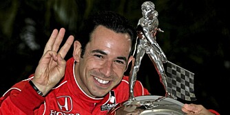 Indianapolis 500 champion Helio Castroneves, of Brazil, poses with the Borg-Warner Trophy during the traditional winner's photo session at the Indianapolis Motor Speedway in Indianapolis, Monday, May 25, 2009. Castroneves won his third Indianapolis 500 Sunday. (AP Photo/Michael Conroy)