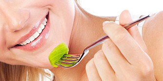 Closeup on beautiful female face eating fruits, health care and diet concept