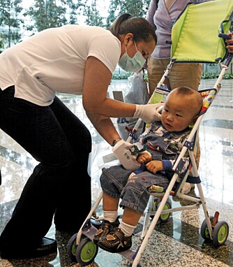 TAR TEMPEN: En helsearbieder måler temperaturen på en liten gutt ved Changi International Airport i Singapore mandag. TAR TEMPEN: En helsearbieder måler temperaturen på en liten gutt ved Changi International Airport i Singapore mandag.