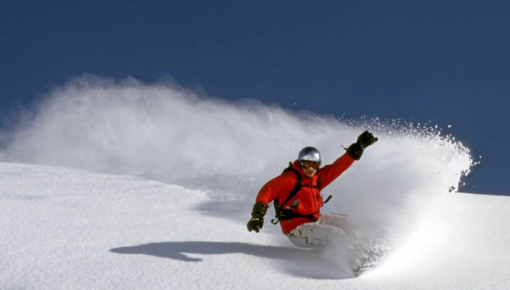 snowboarder is riding fresh powder on a perfect day