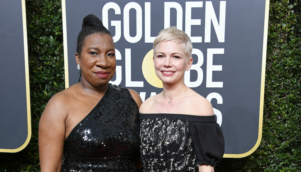 KOM SAMMEN: Tarana Burke kom sammen med Michelle Williams under Golden Globe-utdelingen. Alle de kvinnelige stjernene, og de fleste mannlige, kom kledd i svart for å vise sin støtte til ofre for seksuell trakassering.
