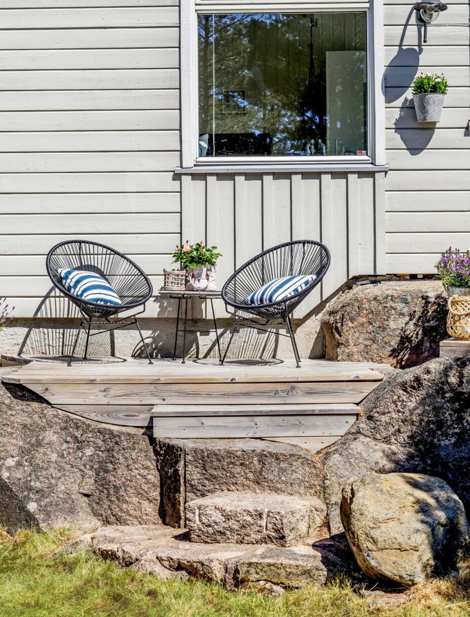 <b>FLYTTBAR TERRASSE:</b> Mellom de store og ujevne steinene ved hytta, har Finn-Erik laget en enkel terrasse som lett kan flyttes. Han brukte impregnerte materialer og bygget en kjegleformet konstruksjon av 48 x 98 mm konstruksjonsvirke. Denne «kjeglen» står som en trakt ned i kløften i svaberget. Deretter la han terrassebord tvers over konstruksjonen. Bordendene ble skåret på skrå, slik at de går i ett med bergknausene. Terrassen er ikke festet på noen måte, men ligger stødig på grunn av tyngden og formen, og kan lett tas opp og flyttes på.