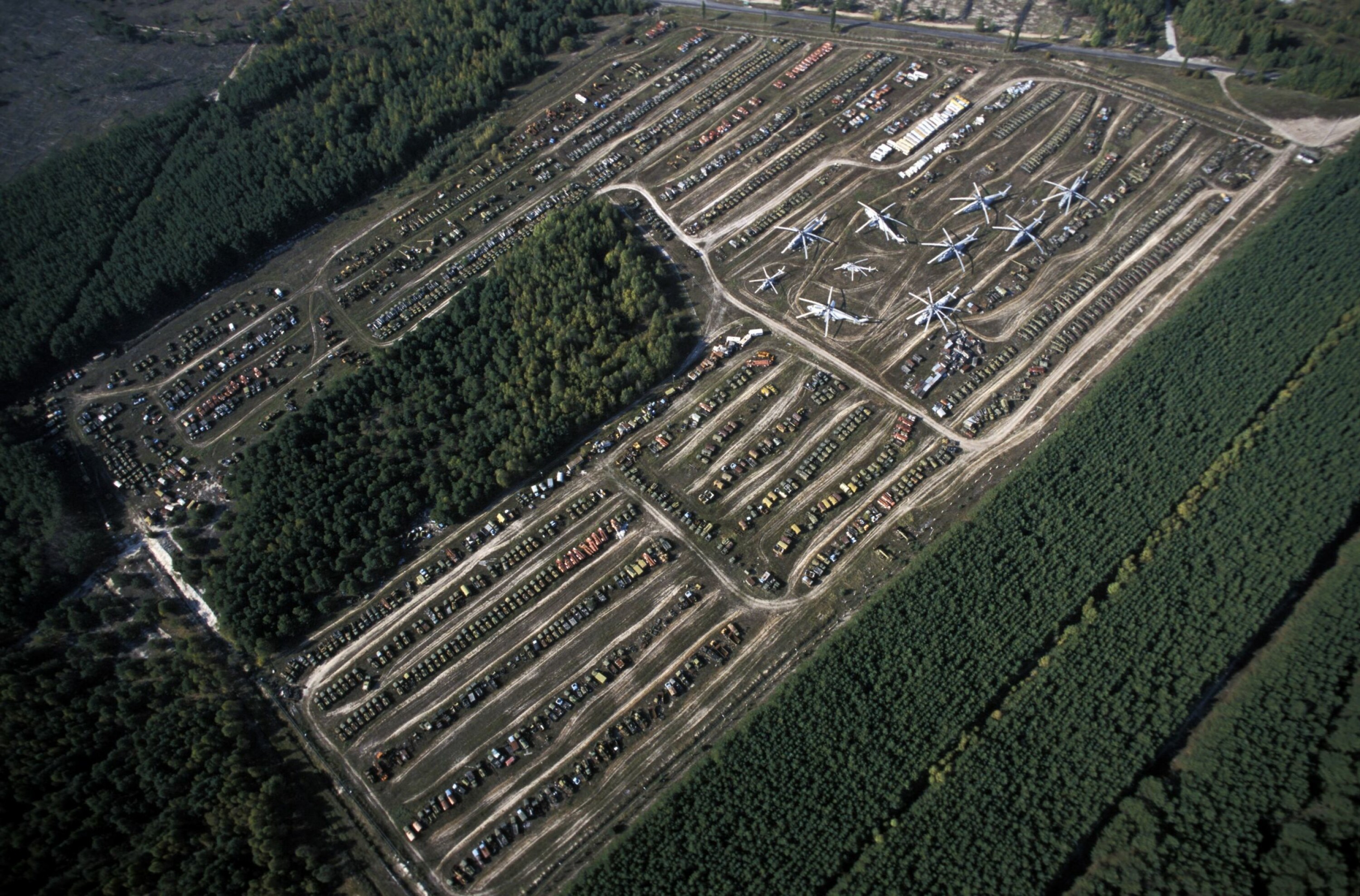STRÅLENDE PARKERING: Noen helikoptre og kjøretøyer har forsvunnet, noen få er renset og tatt i bruk, andre er bare etterlatt på Rassokha-området.
