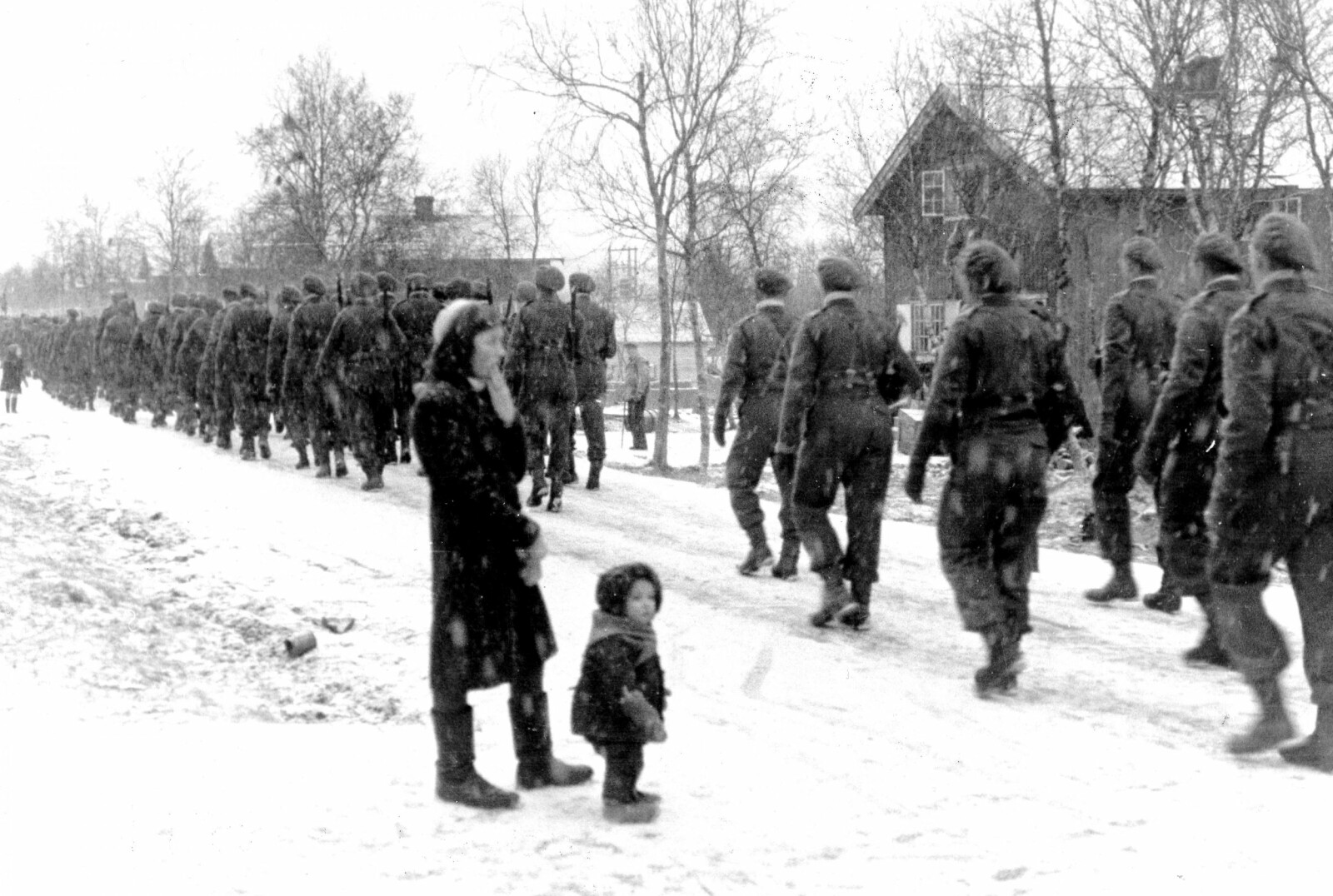 <b>BEFRIERNE:</b> Soldater fra 2. bergkompani marsjerer gjennom gatene i Bjørnevatn i november 1944. Etter kort tid skulle dyp mistillit prege forholdet mellom soldatene og lokalbefolkningen i Finnmark.