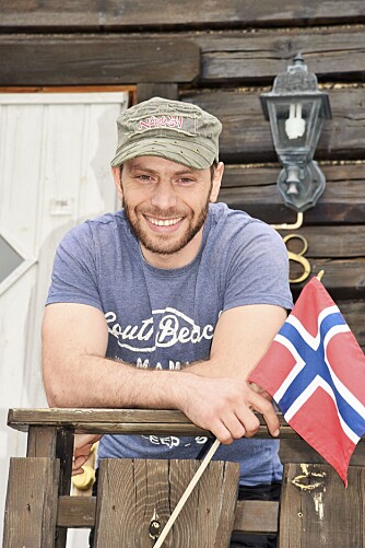 <b>URNORSK:</b> Ahmad bor i en norsk tømmerhytte med det norske flagget hengt på veggen. 