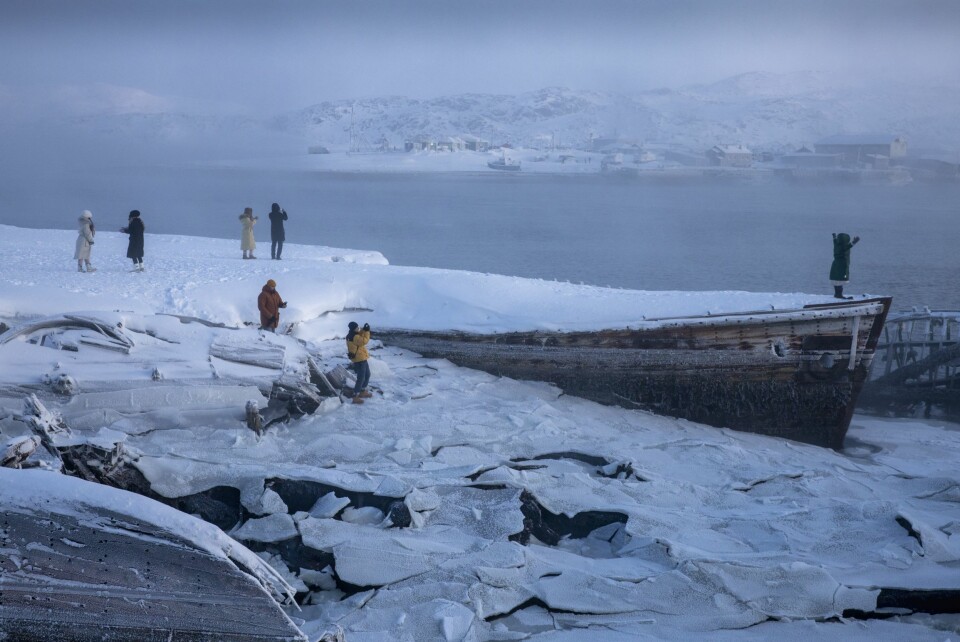 STØY OG STILLHET: Etterlatte båter fra Sovjetdagene og fargerike, støyende kinesiske turister. I bakgrunnen sentrum av Teriberka.