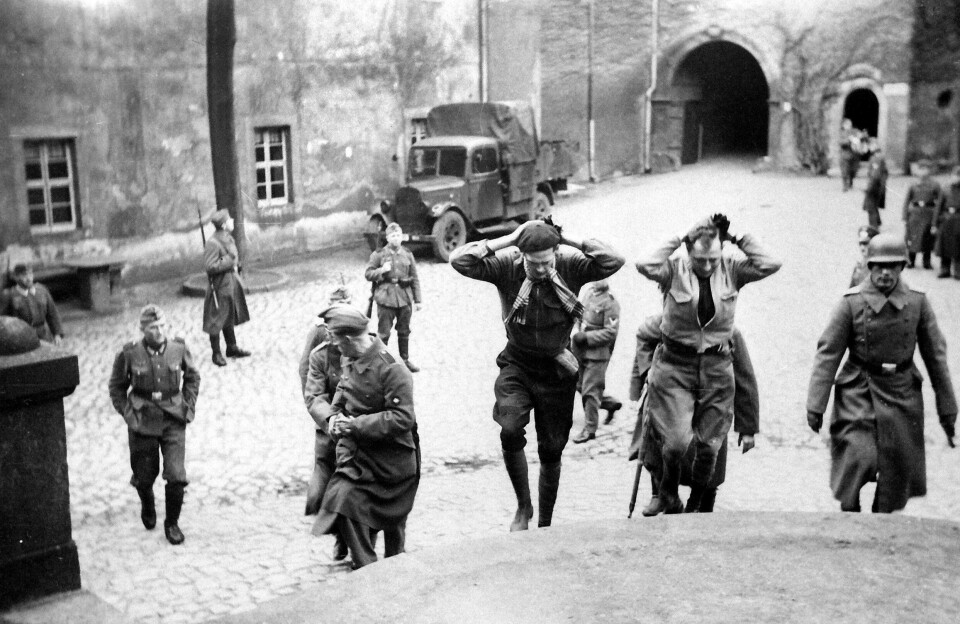 BELGISKE RØMLINGER: Føres tilbake til fangeslottet etter et mislykket fluktforsøk. De innsatte var for øvrig offiserer fra det britiske imperiet, Nederland, Polen og Frankrike.