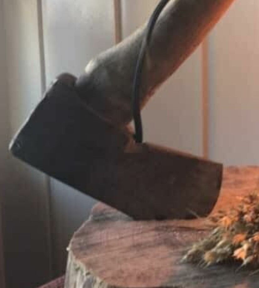 FEST GODT: I tillegg til å slå øksa godt ned i stubben, har Gøril også limt den fast.