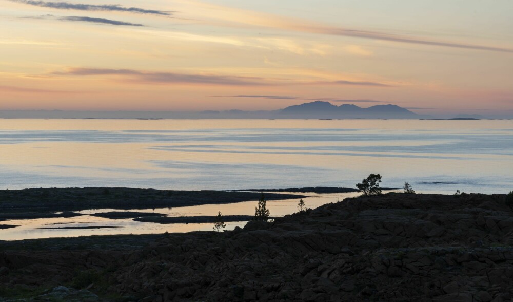 <b>SOLNEDGANG VED HORTA­FJORDEN:</b> Panoramautsikt mot Helgelands­øyene og verneområdene i nord og vest.