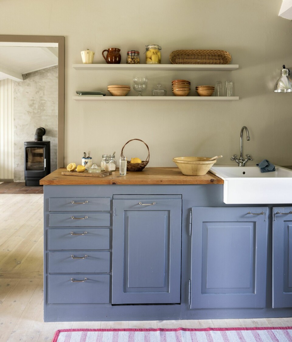 FLOTT I BLÅTT: Kjøkkenskapene har søstrene funnet på dba.dk, hos en mann som selv hadde bygget kjøkkenet av gamle panelskap fra en herskapsleilighet. De har malt kjøkkenmodulene himmelblå og åpnet opp rommet til et stort allrom som passet bedre til de to familienes livsstil.