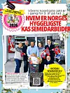 Butikkansatte foran butikkinngang med handlevogn og norske flagg.