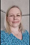 Portrett av kvinne foran lyse fliser innendørs