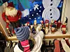 Barn peker på en juleutstilling i butikkvindu med nisser og snømenn.